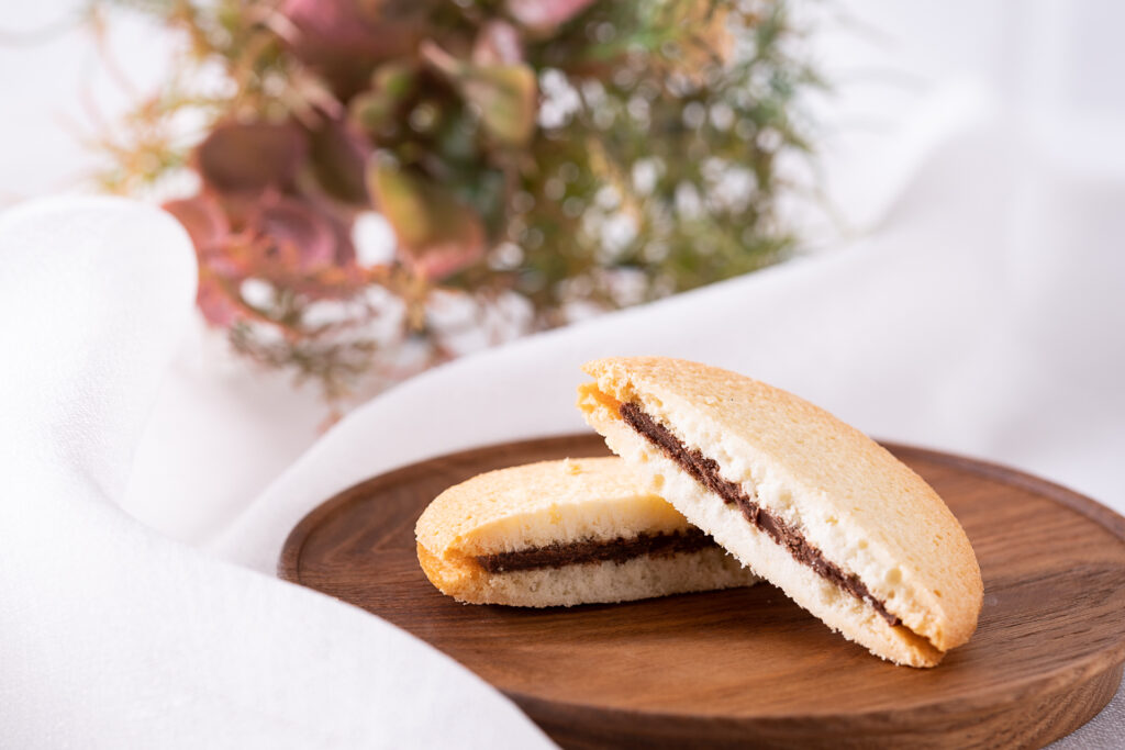 NISEKO CACAO CROWNこだわりのミルクチョコレートをラングドシャクッキーで挟みました。サクサクに焼き上げたクッキーとミルクチョコレートのコラボレーション。